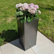 Assorted zinc planters adding flair to a rooftop garden